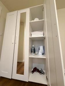 a white cabinet with a mirror in a room at Deluxe Suite near Microsoft in Bellevue