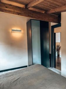 a bedroom with a bed and a wooden ceiling at Residence By Talking Stones in Dolceacqua