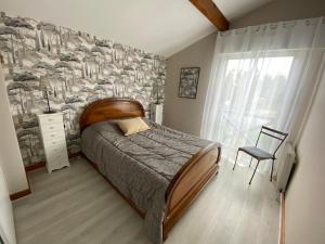 a bedroom with a bed and a large window at maison Basque Maïana in Anglet