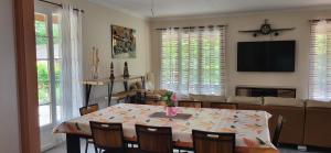 a living room with a table and a couch at Chez maman in Bassan