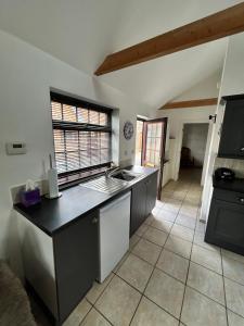 a kitchen with a sink and a counter top at The Old Stables in Mews in Kessingland