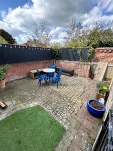 a patio with a table and chairs and a fence at The Old Stables in Mews in Kessingland
