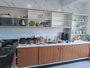 a kitchen with a counter with food on it at Pousada casa da amizade in Penha