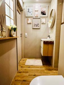 a bathroom with a toilet and a sink at Extravagantes Apartment in Potsdam +8 photos