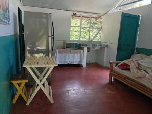 a room with a room with a table and a bed at Hojasen Accommodation in Puerto Jiménez