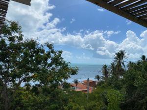 a view of the ocean from a house at Chalé Green Vila Mathilde in Icapuí