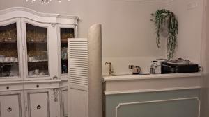 a kitchen with a white cabinet and a microwave at B&B Domus Aurea 20 in San Giovanni Teatino