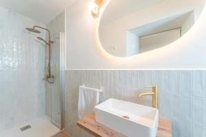 a bathroom with a white sink and a mirror at Apartamentos Turísticos Zibá in Merida +54 photos