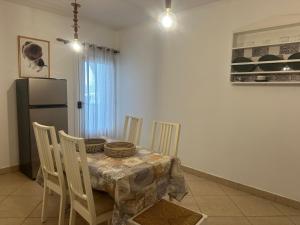 a kitchen with a table with chairs and a refrigerator at Mikes apartment in Naousa