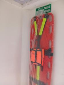 a red suitcase is hanging on a wall at Casa turistica Miss G in Providencia +16 photos
