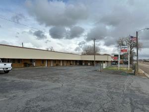 an empty parking lot in front of a motel at Sportsman Motel in Malta