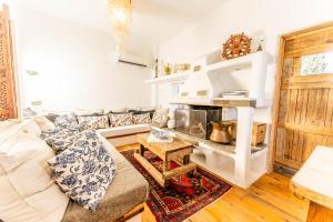 a living room with a couch and a table at Maison De Yaya at Heraion Lagoon in Loutraki
