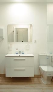 a white bathroom with a sink and a toilet at Only for Women Hostel Madrid-Sol in Madrid +22 photos