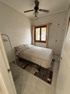 a bedroom with a bed and a ceiling fan at Bravo Hills - Casa Jean in Ciudad Quesada