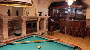 a pool table in a room with a fireplace at Orion Guest Villa Casais in Lousada