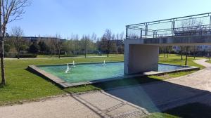 a building with a pool with swans in a park at Orion Guest Villa Casais in Lousada