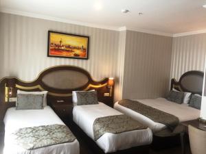 A bed or beds in a room at The Central Hotel