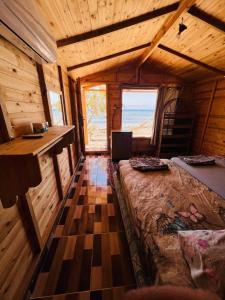 a room with a bed and a desk in a cabin at The White Beach in Nuweiba