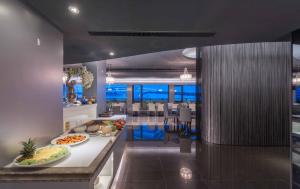 a kitchen and dining room with food on a counter at Forward Hotel Taipei Nangang in Taipei