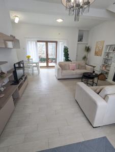a living room with two couches and a tv at House in Gardos in Zemun