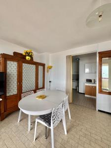 a living room with a white table and chairs at Aqua Appartement in La Grande-Motte