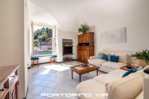 a living room with a couch and a table at Greca by PortofinoVip, Seaview, AC in Portofino
