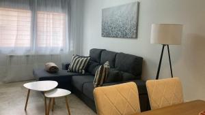 a living room with a blue couch and a table at Apartamento Bellarhouse I in Ciudad Real +16 photos