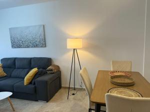 a living room with a blue couch and a table at Apartamento Bellarhouse I in Ciudad Real