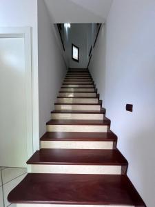 a staircase in a building with brown wooden floors at Villa Mamma Francesca in Salemi +42 photos