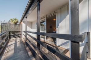 a balcony of a house with a wooden railing at Orion Suite - Compact Stay with Essentials in Lake Tekapo