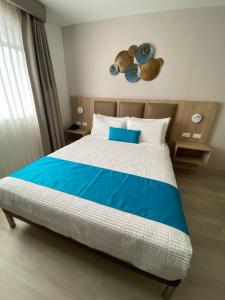 Voodi või voodid majutusasutuse Hotel Cumbayá Sanvy toas