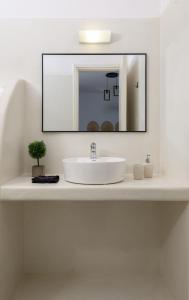 a bathroom with a sink and a mirror at Blue Heart Luxury Suites in Agia Anna Naxos +68 photos