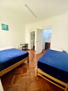 Ένα ή περισσότερα κρεβάτια σε δωμάτιο στο Gutierrez Hostel