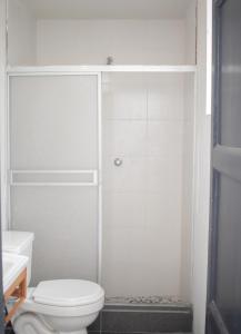 bagno bianco con doccia e servizi igienici di Gutierrez Hostel a Lima