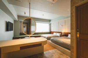 Postel nebo postele na pokoji v ubytování Hotel Vintage Tokyo Meguro Fudomae