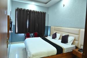a bedroom with a large bed with a window at Hotel Gopal Inn in Amritsar
