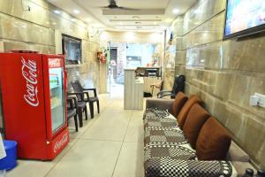 a coca cola machine in a room with a couch at Hotel Gopal Inn in Amritsar