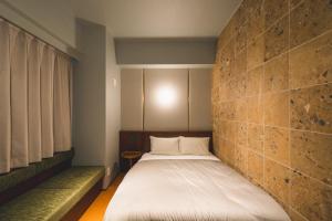 Postel nebo postele na pokoji v ubytování Hotel Vintage Tokyo Meguro Fudomae