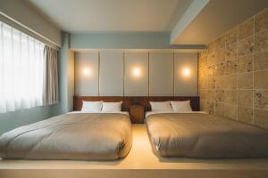 Postel nebo postele na pokoji v ubytování Hotel Vintage Tokyo Meguro Fudomae