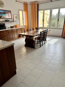 a kitchen with a wooden table and chairs in a room at casa solemar in La Maddalena +37 photos
