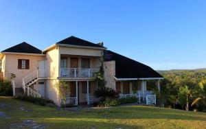 a large house with a balcony on a lawn at Escape to ParakeetHill B&B in Jones Pen