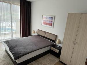 a bedroom with a bed and a large window at Panoramic Sea View Apartment in Byala