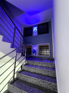a set of stairs with purple lights on them at Appartement cosy à Reghaia Plage pour les familles in Reghaïa