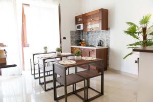 a kitchen with a table and some chairs at Suite Room Con Vasca Idromassaggio in Aversa +48 photos