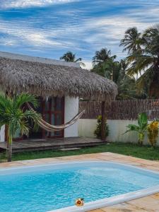 a resort with a swimming pool in front of a building at Moitas Chalés in Amontada +15 photos