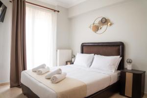 a bedroom with a bed with two towels on it at Nireas Blue Balcony by Raise in Áno Váthia +40 photos