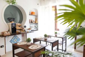 a coffee shop with three tables in a room at Suite Room Con Vasca Idromassaggio in Aversa