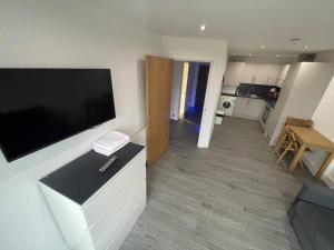 a living room with a large flat screen tv on a wall at Ilford Tower Apartments in Ilford +56 photos
