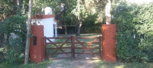 an entrance to a gate with a wooden fence at Arroyo seco playa hermosa in Arroyo Seco
