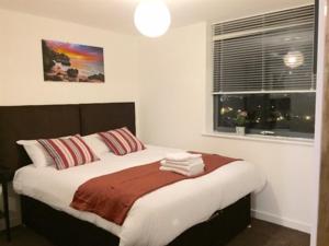 Giường trong phòng chung tại Stratford Luxury Apartments